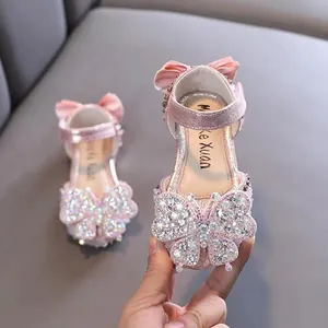 Elegant pink princess sandals for girls featuring a large rhinestone butterfly and soft sole