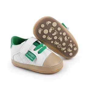 Detail view of baby prewalker shoes with white leather upper and non-slip patterned sole