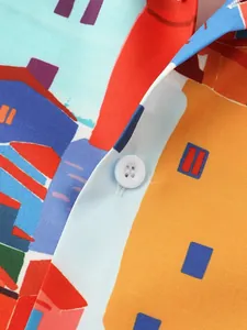 Close-up of vibrant townscape print on casual short-sleeved beach shirt