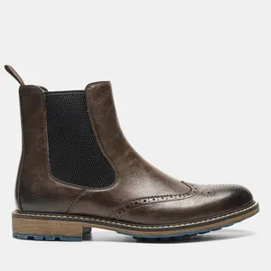 Side profile of vintage brown men's Chelsea boots with wingtip brogue detailing