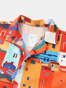 Detail of men's casual beach shirt featuring a colorful architectural village print.