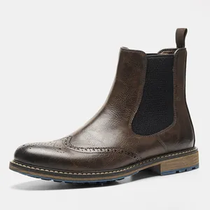 Side view detail of men's vintage brown brogue Chelsea boots with classic wingtip design