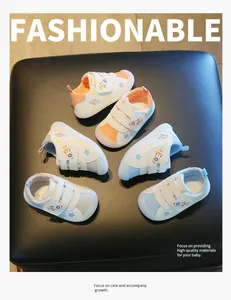 Detailed view of colorful toddler shoes with rocket patterns and velcro straps