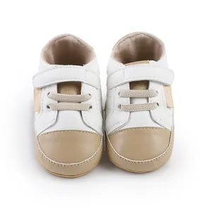 Front view of baby walking shoes for infants in white and beige soft faux leather
