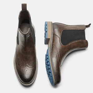 Top-down view of men's brown brogue Chelsea boots with decorative blue lug sole.
