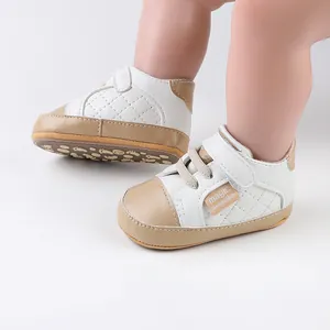 Detail view of quilted baby prewalker shoes in white and beige with Velcro strap.