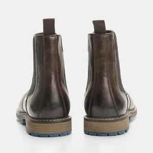 Rear view of brown vintage men's Chelsea boots showing leather texture and pull tab