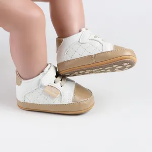 Detailed view of white quilted baby walking shoes with anti-slip tan rubber soles