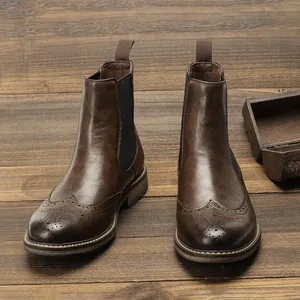 Premium vintage brown men's Chelsea boots with detailed brogue carving on wood