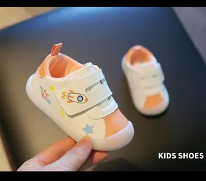 Detail view of toddler walking shoes with rocket pattern and soft jelly sole