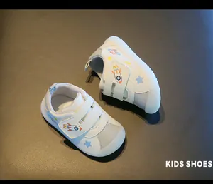 A detailed view of white baby walking shoes featuring soft jelly soles and rocket motifs
