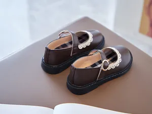 Elegant brown girls' Mary Jane leather shoes featuring white lace trim and plaid lining.