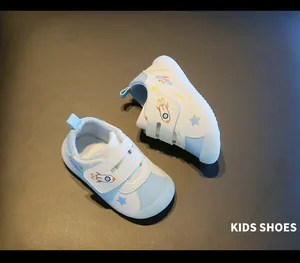 Top-down view of toddler walking shoes with blue space patterns and velcro strap