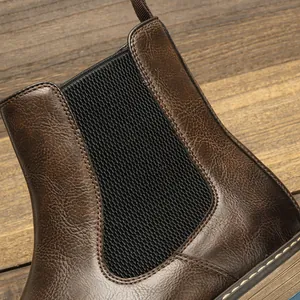 Close-up of vintage brown leather Chelsea boot featuring black elastic side panel detail
