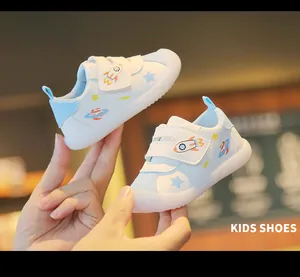 Close-up of white baby toddler shoes with space patterns and soft jelly soles.