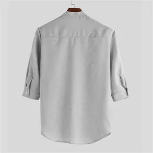 Back view of grey polyester men's shirt with three-quarter sleeves and stand collar.