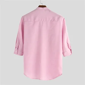 Back view of a pink men's 3/4 sleeve shirt with mandarin collar and textured fabric