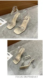 Detailed view of square toe rhinestone bow sandals with transparent straps and wine glass heel
