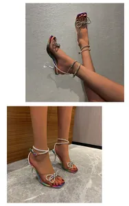 Detailed view of iridescent square toe sandals with rhinestone bow and wine glass heels.