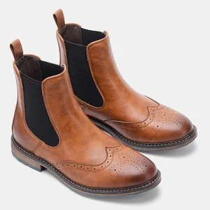 Close-up of vintage brown brogue Chelsea boots with stylish perforated wingtip detail