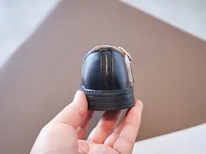 Detailed heel view of girls' black leather Mary Jane shoes with fine stitching