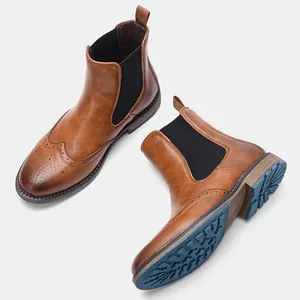 Detailed view of vintage brown brogue Chelsea boots featuring unique blue textured soles