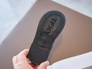 Detailed macro view showing the anti-slip black rubber sole of a girls' Mary Jane shoe