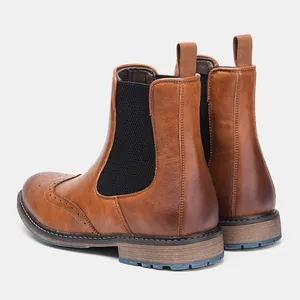 Rear view detail of brown leather Chelsea boots with elegant brogue wingtip patterns