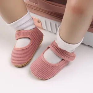 Vue détaillée des chaussures de marche rose en velours côtelé pour bébé fille.