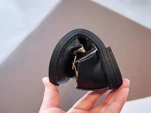 Close-up showing the extreme flexibility and soft sole of the girls' black Mary Jane shoes