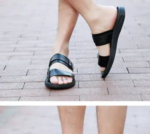 Detailed macro view of men's black leather sandals worn on outdoor brick pavement