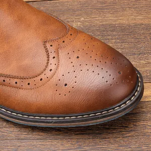 Detailed close-up of vintage brown men's brogue boots with wingtip perforations