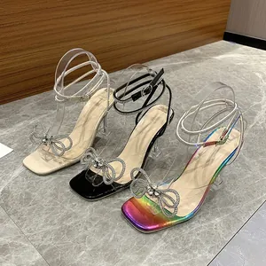 Elegant square toe sandals featuring rhinestone bow accents and clear glass heels