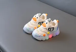 Detail view of light-up toddler sneakers with cute cartoon duck design and breathable mesh