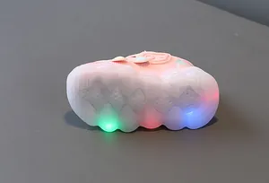 Detail shot of pink toddler shoe with colorful LED light-up sole on grey surface