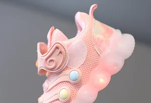 Macro detail of breathable mesh pink toddler sneaker featuring a glowing LED light-up sole