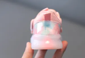 Close-up view of a pink toddler walking shoe with a bright glowing LED heel light