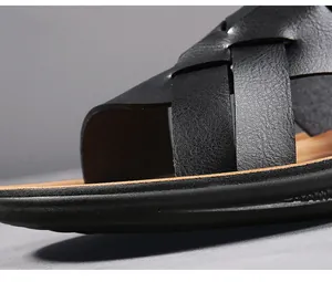 Detailed macro view of black woven leather straps on men's outdoor summer sandals