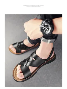 Detailed view of men's black leather sandals with cross-strap design and soft sole