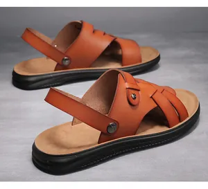 Detailed macro view of brown men's leather sandals showing soft breathable texture and soles.