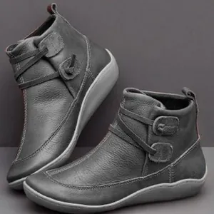 Side detail of women's grey British style flat ankle boots featuring unique strap design