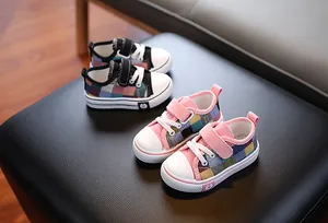 Close-up of low-top plaid canvas shoes for toddlers in pink and black colorways