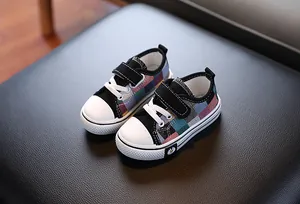 Detailed close-up of children's low-top plaid canvas sneakers with velcro straps