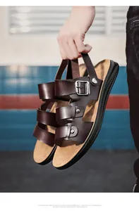 Detail view of men's casual brown leather sandals with adjustable buckles and straps