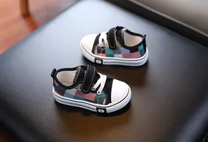 Close-up of colorful patchwork toddler canvas shoes with velcro straps and daisy detail