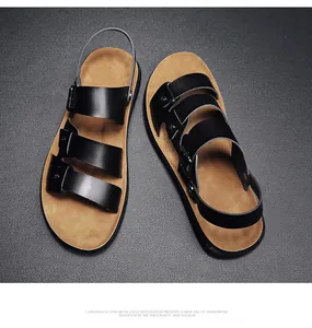 High-angle view of premium men's black leather two-way sandals on textured surface