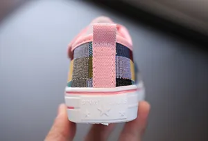 Macro view of patchwork canvas child shoe heel with pink trim and white rubber sole