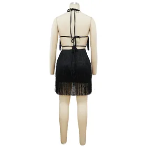 Detailed back view showing the fringe texture and criss-cross lace-up straps of the black dress