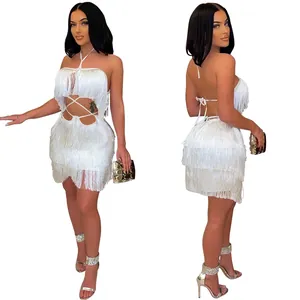 Close-up view of white fringe mini dress featuring sexy waist cutouts and halter neck design
