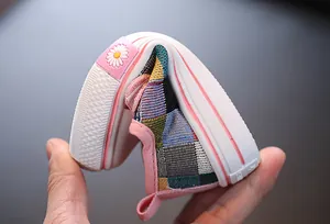 Close-up view of a highly flexible children's patchwork canvas shoe showing its soft rubber sole